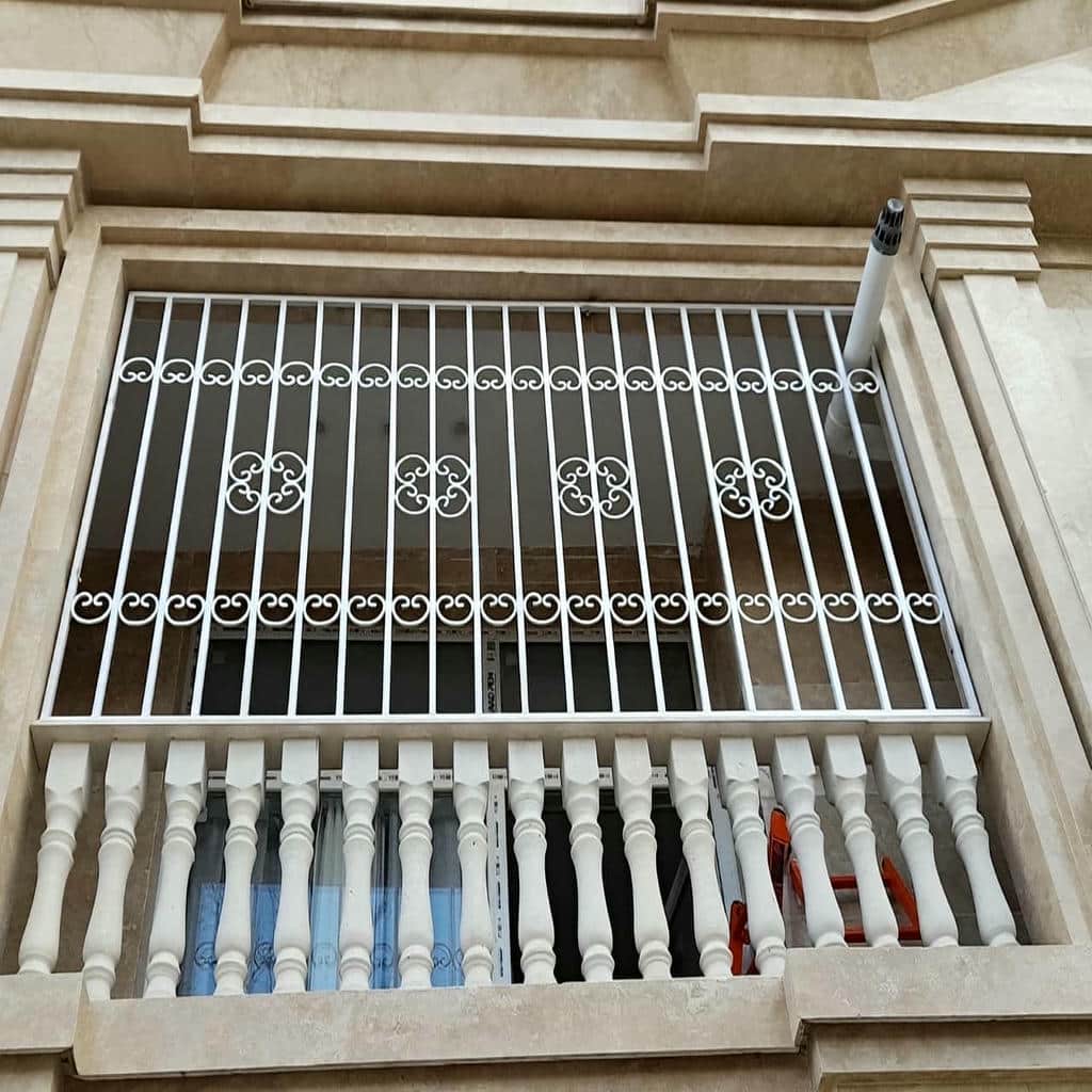 اجرای نرده پنجره فرفورژه گل‌دار با طرح پیچکی در کرمان